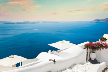 Beautiful sunset at Santorini island, Greece. White architecture on the rocks with sea view. Famous...