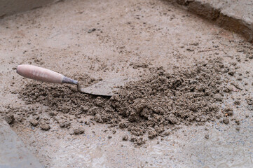 Grounds are being plastered using trowel and cement manually, Stock image.