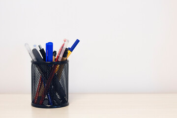 pencils in pencil case on white office desk