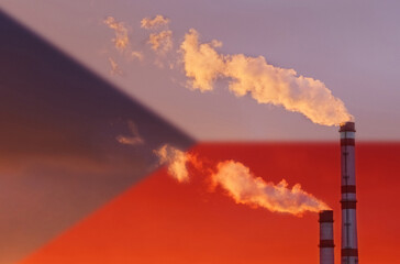 Against the background of the flag of the Czech Republic, smoke is coming from the chimneys of the enterprise.