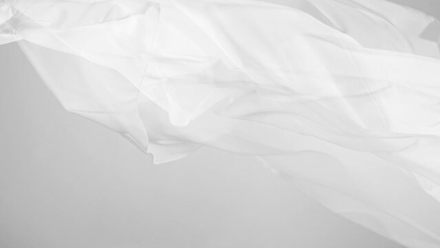 White transparent silk fabric flowing by wind