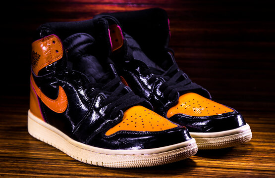 Sneakers Nike Air Jordan Orange On Wooden Bacground