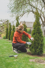 Agriculture.Girl agronomist takes care of plants in the garden at home.Cottagecore,garden house,Ecology,meditation,connection with nature.Agro,eco