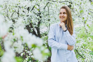 Portrait of beautiful romantic lady in apple trees blossoms