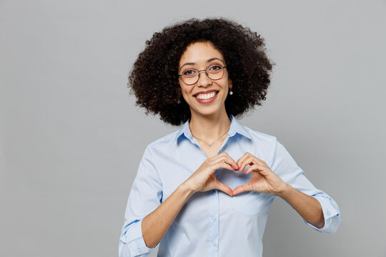 Young Employee Business Corporate Lawyer Woman Of African American Ethnicity In Classic Formal Shirt Work In Office Showing Shape Heart With Hands Heart-shape Sign Isolated On Grey Color Background.