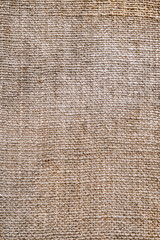 Background, texture of a fabric woven in spots of dirty burlap close-up. Photography, abstraction.