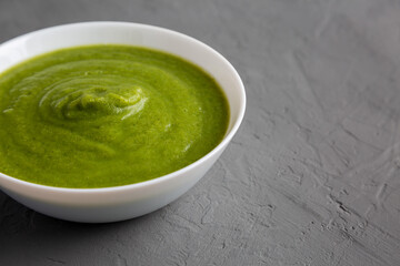 Homemade Organic Broccoli Soup on gray background, side view. Copy space.