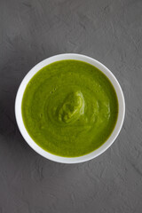 Homemade Organic Broccoli Soup on gray background, top view. Flat lay, overhead, from above.