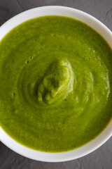 Homemade Organic Broccoli Soup on gray background, top view. Flat lay, overhead, from above.