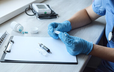 Ampoule and syringe in the hands of a doctor in blue gloves. Medicine, healthcare concept. Vaccination.