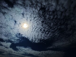 Dramatic sky clouds and moon at mysterious night. 