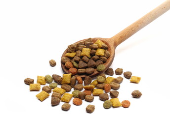 Dry cat food in wooden spoon isolated on white 