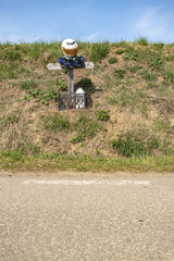 Memorial cross at the scene of a biker's fatal accident on the side of the road. Biker helmet on...