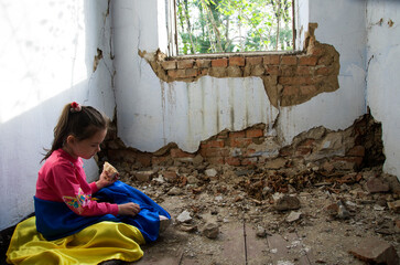 humanitarian catastrophe. The child eats in a bomb shelter. War in Ukraine. Frightened child in a...