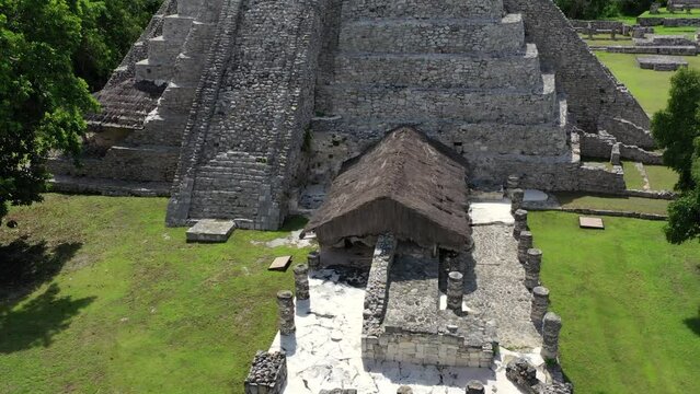Aerial drone footage, flying around and circling the stone ruins of an ancient latin American tribe who built the city.  The pyramid being the biggest structure of the city.