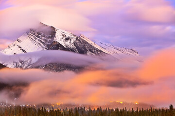 Mount Rundle and Banff Townsite at dusk, motion blurred clouds, Banff National Park, Alberta, Canada.