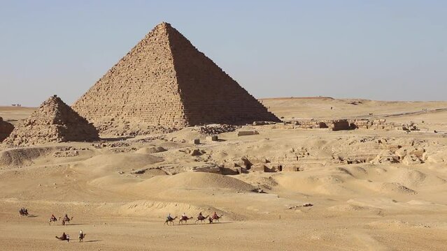 Pyramid Khafre with row of walking camels Giza, Cairo Egypt