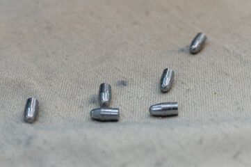 Small caliber bullets on rough fabric at production plant