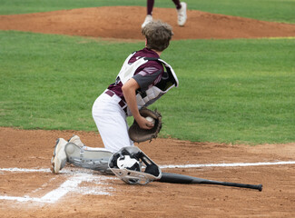 Action photo of high school baseball players making amazing plays during a baseball game