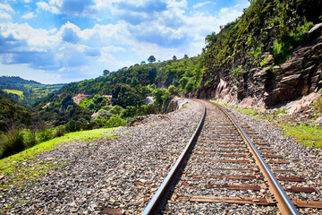 Fototapeta na wymiar old railway with sky cloudy and nature vegetation around in the mogote state of mexico el oro 