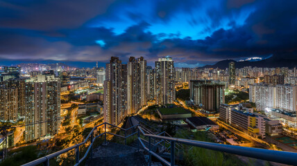 Aerial shot of a scenic twilight skyline of Kowloon's eastern cityscape with illuminations at night