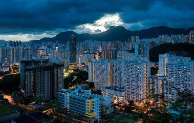 Aerial shot of a scenic twilight skyline of Kowloon's eastern cityscape with illuminations at night