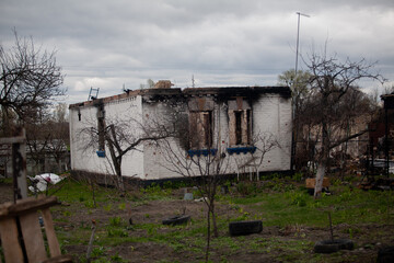 Fototapeta na wymiar Burnt private house after Russian bombardment