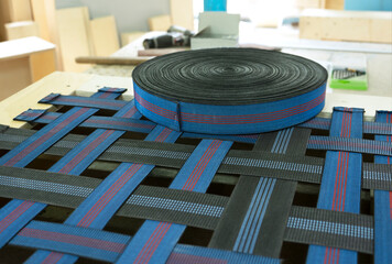 Elastic band for furniture production industry on a sofa. Furniture is ready for upholstery....