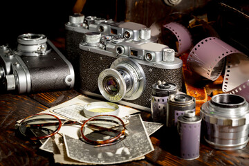 Old vintage photo cameras on an old background.