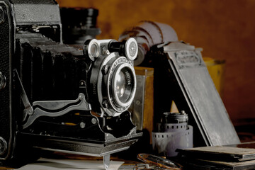 Old vintage photo cameras on an old background.