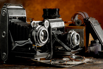 An old camera in a composition on an old background, on a table