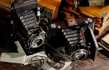 Old vintage photo cameras on an old background.