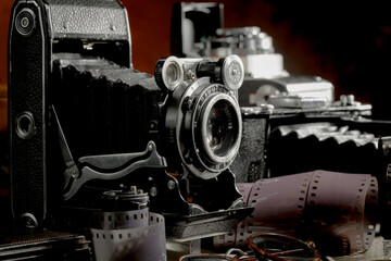 An old camera in a composition on an old background, on a table