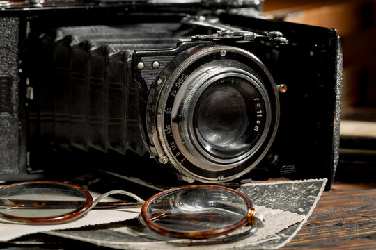 Old camera in the studio on an old background