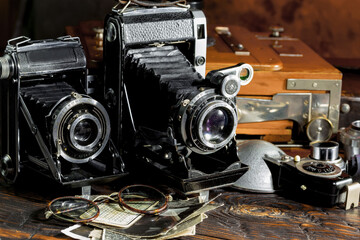 Fototapeta na wymiar Old vintage cameras on an old background.