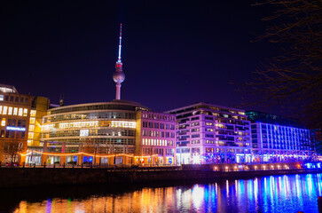 Mesmerizing shot of Berlin city with Alexanderplatz illuminated by lights at night