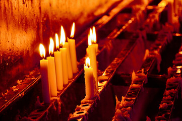 Candle holder with burning candles in a church