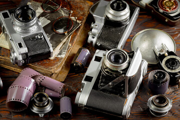 Old vintage photo cameras on an old background.