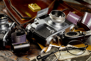 Old vintage photo cameras on an old background.