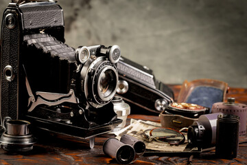 Old vintage photo cameras on an old background.