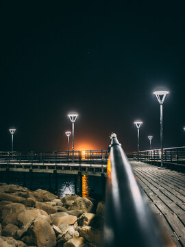 Vertical shot of a bridge over the sea at night in Limassol, Cyprus