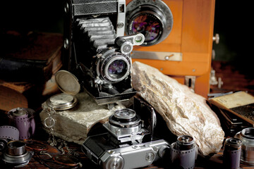 Old vintage photo cameras on an old background.
