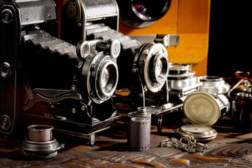 An old camera in a composition on an old background, on a table