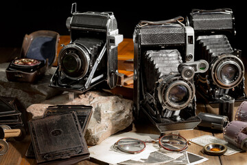 An old camera in a composition on an old background, on a table