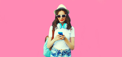 Summer colorful portrait of stylish modern young woman listening to music in headphones with...