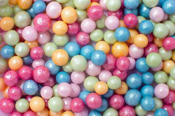 Fototapeta na wymiar Multicolored spheres, popular sugar confectionery sprinkles, solid background.