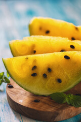 Fresh ripe sliced yellow watermelon on wooden background