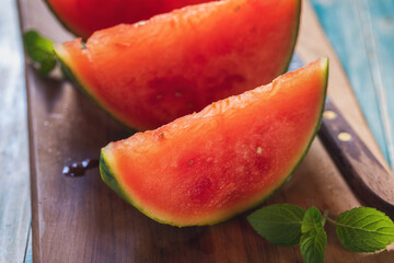 Fresh ripe sliced watermelon on wooden background