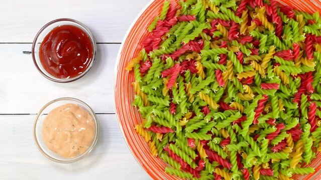 Multicolored uncooked raw italian fusilli pasta.