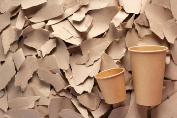 Coffee cup at waste paper background texture. Recycling concept